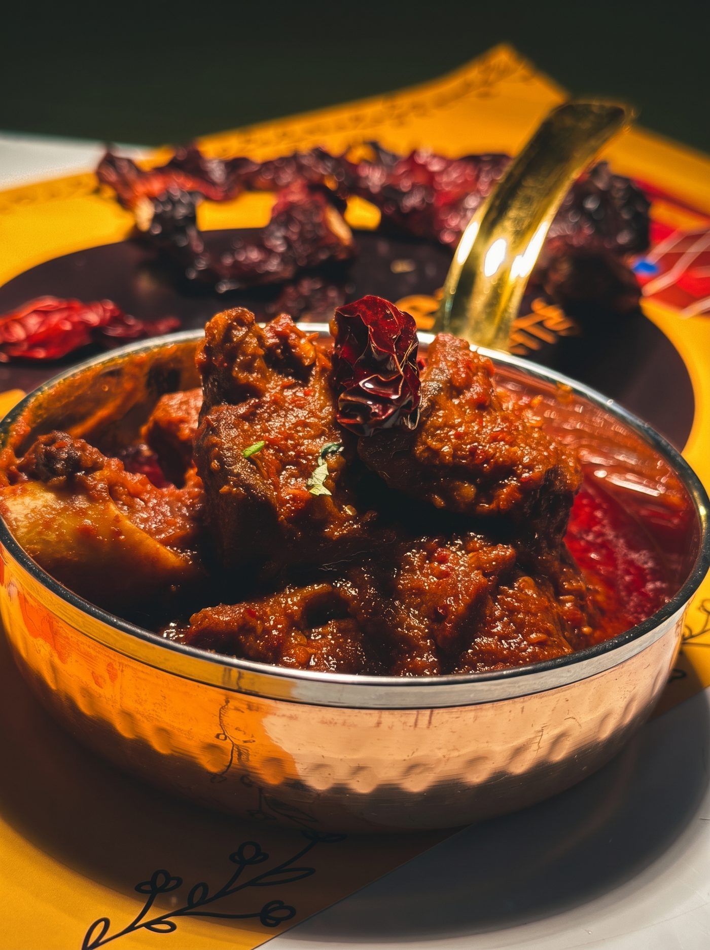 Curry served in a copper handi